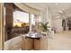 An elegant dining area features large windows with sunset views, custom light fixture, and seating at 6621 N Arizona Biltmore Cir, Phoenix, AZ 85016