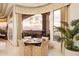 Dining area with bay window, scenic views, and elegant lighting for a cozy atmosphere at 6621 N Arizona Biltmore Cir, Phoenix, AZ 85016