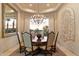 Elegant dining room featuring custom wall art, large window and chandelier at 6621 N Arizona Biltmore Cir, Phoenix, AZ 85016