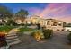 Elegant home featuring manicured landscaping, a circular driveway, and multiple car garage at 6621 N Arizona Biltmore Cir, Phoenix, AZ 85016