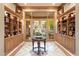 Foyer with marble floors and a large window view of the pool and lush backyard at 6621 N Arizona Biltmore Cir, Phoenix, AZ 85016