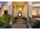 Stone accented doorway features an ornate wrought iron gate and lush landscaping at 6621 N Arizona Biltmore Cir, Phoenix, AZ 85016