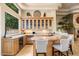 Modern kitchen features granite countertops, custom cabinets, stainless steel appliances, and a breakfast bar at 6621 N Arizona Biltmore Cir, Phoenix, AZ 85016