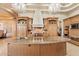 An elegant kitchen with a large center island, granite countertops, and stainless steel appliances at 6621 N Arizona Biltmore Cir, Phoenix, AZ 85016