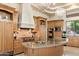 Spacious kitchen features custom cabinets, granite counters, stainless appliances, and decorative lighting at 6621 N Arizona Biltmore Cir, Phoenix, AZ 85016