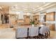 Open-concept kitchen with seating at large island, custom cabinets and stone countertops at 6621 N Arizona Biltmore Cir, Phoenix, AZ 85016