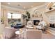 Cozy living room with fireplace, neutral tones, and large windows offering natural light at 6621 N Arizona Biltmore Cir, Phoenix, AZ 85016
