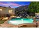 Backyard pool and rock waterfall feature, showcasing desert sunset views at 6621 N Arizona Biltmore Cir, Phoenix, AZ 85016