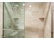 Walk-in shower features beige tile surround, glass door, and handheld shower head at 6621 N Arizona Biltmore Cir, Phoenix, AZ 85016
