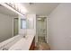 Bathroom featuring a double sink vanity with modern fixtures and a shower at 10 E Betty Elyse Ln, Phoenix, AZ 85022