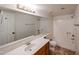 Bathroom featuring a single sink vanity and a shower-tub combo at 10 E Betty Elyse Ln, Phoenix, AZ 85022