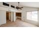 Bright bedroom with carpet, ceiling fan, and multiple doors to bathroom and living space at 10 E Betty Elyse Ln, Phoenix, AZ 85022