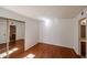 The bedroom has wood floors and a mirrored closet at 10 E Betty Elyse Ln, Phoenix, AZ 85022