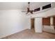 Bright carpeted bedroom with a ceiling fan and stairway door at 10 E Betty Elyse Ln, Phoenix, AZ 85022