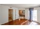 Bedroom with wood floors and access to bathroom and living space at 10 E Betty Elyse Ln, Phoenix, AZ 85022