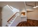 Bright entryway featuring a staircase, wood floors, and views of the kitchen at 10 E Betty Elyse Ln, Phoenix, AZ 85022