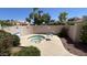 Community hot tub is surrounded by lush landscaping and includes lounge chairs at 10 E Betty Elyse Ln, Phoenix, AZ 85022