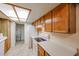 Cozy kitchen featuring white appliances, wood cabinets, and a walk-in pantry at 10 E Betty Elyse Ln, Phoenix, AZ 85022