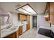 Kitchen showcasing white appliances, light countertops, and light wood cabinets at 10 E Betty Elyse Ln, Phoenix, AZ 85022