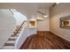 Spacious living room featuring a staircase, wood floors, and views of the kitchen at 10 E Betty Elyse Ln, Phoenix, AZ 85022