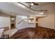 Open-concept living room with high ceilings, wooden floors, and a staircase at 10 E Betty Elyse Ln, Phoenix, AZ 85022