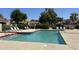 Outdoor community pool with lounge chairs on a sunny day at 10 E Betty Elyse Ln, Phoenix, AZ 85022
