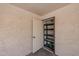 Covered storage area features built-in shelving, storage space, and a door at 10 E Betty Elyse Ln, Phoenix, AZ 85022