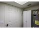 Utility room featuring a water heater and storage cabinets at 10 E Betty Elyse Ln, Phoenix, AZ 85022
