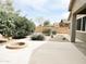 Spacious backyard featuring a fire pit, low-maintenance gravel landscaping, and block wall at 1024 W Ayrshire Trl, San Tan Valley, AZ 85143