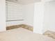 Bedroom with carpet flowing into den with built-in shelving and on suite bathroom at 1024 W Ayrshire Trl, San Tan Valley, AZ 85143