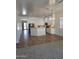 Open kitchen features white cabinets, stainless steel appliances, and tile flooring at 1024 W Ayrshire Trl, San Tan Valley, AZ 85143