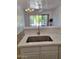 Modern kitchen island featuring white countertops and stainless steel sink at 1024 W Ayrshire Trl, San Tan Valley, AZ 85143