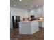 Spacious kitchen with white cabinetry, island, and stainless steel appliances at 1024 W Ayrshire Trl, San Tan Valley, AZ 85143