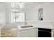 Open-concept kitchen featuring an island and white cabinets at 1024 W Ayrshire Trl, San Tan Valley, AZ 85143