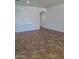 Open living room with neutral walls, tile flooring, and space for furniture at 1024 W Ayrshire Trl, San Tan Valley, AZ 85143