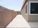 Cement side yard alongside a home, featuring a block wall and a gate, offers privacy at 1024 W Ayrshire Trl, San Tan Valley, AZ 85143