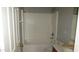 A standard bathroom with a bathtub and a tiled wall at 11218 W Glenrosa Ave, Phoenix, AZ 85037