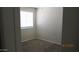 Bright, carpeted bedroom with natural light from the window and neutral paint at 11218 W Glenrosa Ave, Phoenix, AZ 85037