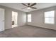Bedroom featuring neutral walls, carpet, ceiling fan and en-suite bathroom at 11218 W Glenrosa Ave, Phoenix, AZ 85037