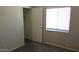 A simple bedroom featuring carpet, one window, and a standard door to the closet at 11218 W Glenrosa Ave, Phoenix, AZ 85037