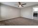 Neutral bedroom with ceiling fan and carpet flooring at 11218 W Glenrosa Ave, Phoenix, AZ 85037