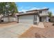 Two story home with a two car garage and desert landscaping at 11218 W Glenrosa Ave, Phoenix, AZ 85037