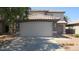 Two-story home featuring a large two car garage, tile roof, and a concrete driveway at 11218 W Glenrosa Ave, Phoenix, AZ 85037