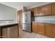 Kitchen features stainless steel appliances, ample oak cabinets, and granite countertops at 11218 W Glenrosa Ave, Phoenix, AZ 85037
