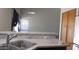 Eat in Kitchen featuring granite counters, stainless steel sink, and natural wood cabinets at 11218 W Glenrosa Ave, Phoenix, AZ 85037