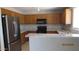 A modern kitchen featuring stainless steel appliances and wood cabinets and granite countertops at 11218 W Glenrosa Ave, Phoenix, AZ 85037