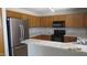 A modern kitchen featuring stainless steel appliances and wood cabinets and granite countertops at 11218 W Glenrosa Ave, Phoenix, AZ 85037