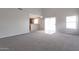 Spacious living room featuring carpet floors and backyard access at 11218 W Glenrosa Ave, Phoenix, AZ 85037