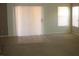 Bright living room with carpet and tile flooring, sliding glass doors, and natural light at 11218 W Glenrosa Ave, Phoenix, AZ 85037