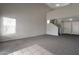 Open living room boasts neutral paint, plush carpet and a vaulted ceiling at 11218 W Glenrosa Ave, Phoenix, AZ 85037